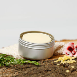 Rosemary & Geranium Solid Lotion Bar in tin with flowers